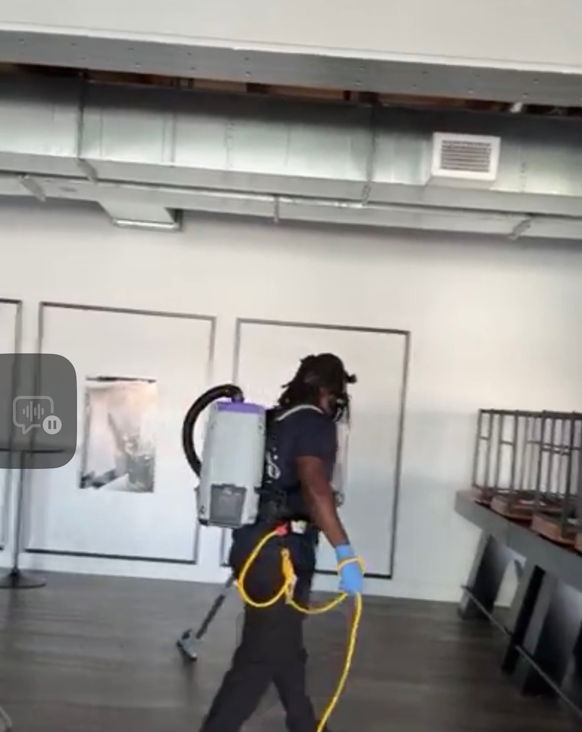 Next Level Commercial Cleaning professional using backpack vacuum in a modern DC office